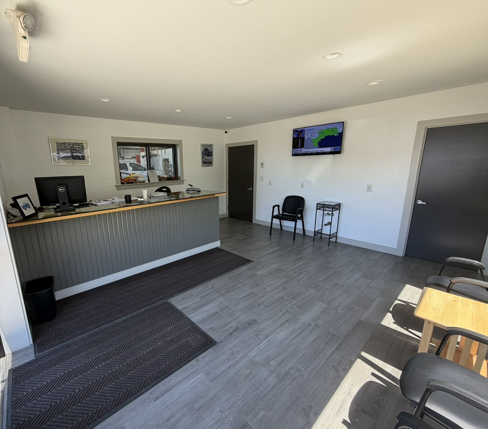 The waiting room at JDeB's Garage — clean, bright, with a view into the shop